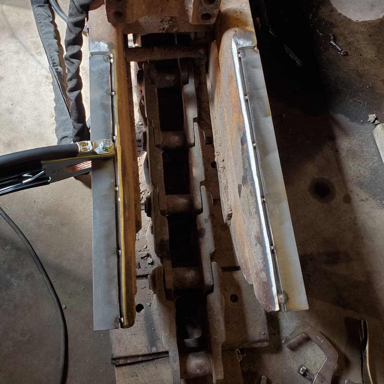 Heavy equipment undercarriage being repaired and welded at V Bush Welding